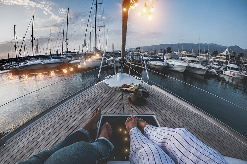 Couple's Legs sitting on a boat